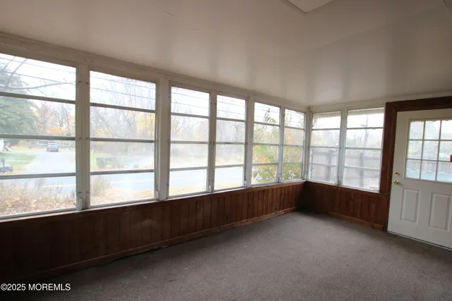 an empty room with large windows