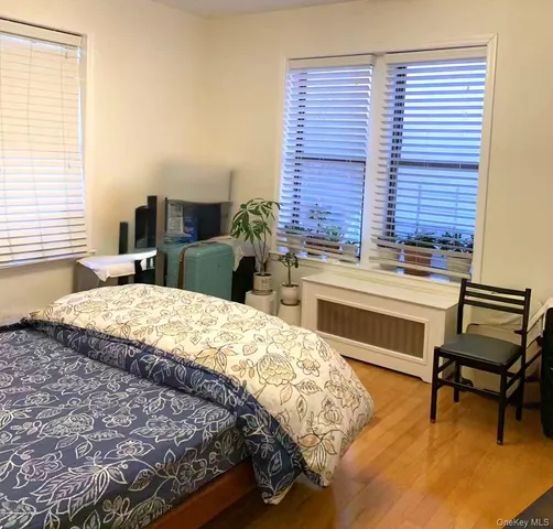 a bedroom with a bed and a desk