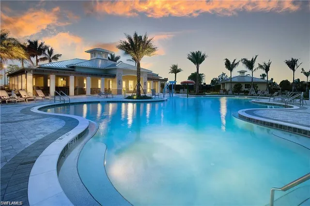 a view of a swimming pool with outdoor seating