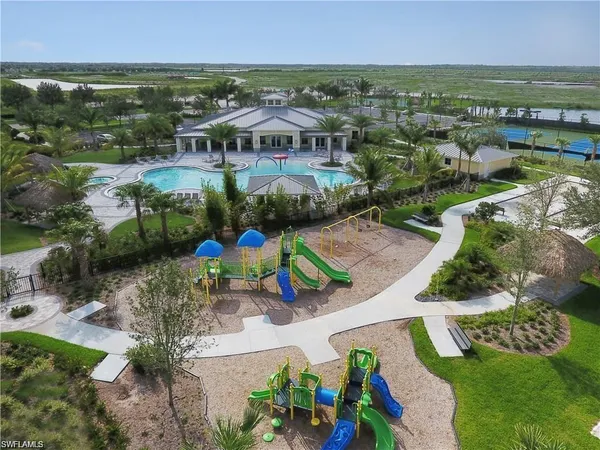 an aerial view of residential houses with outdoor space and river