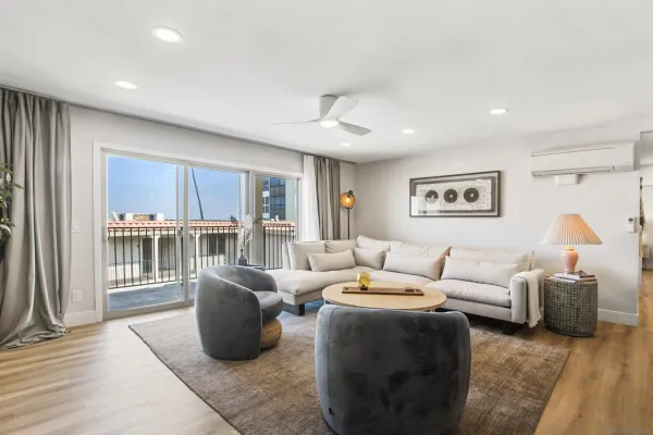 a living room with furniture and a wooden floor