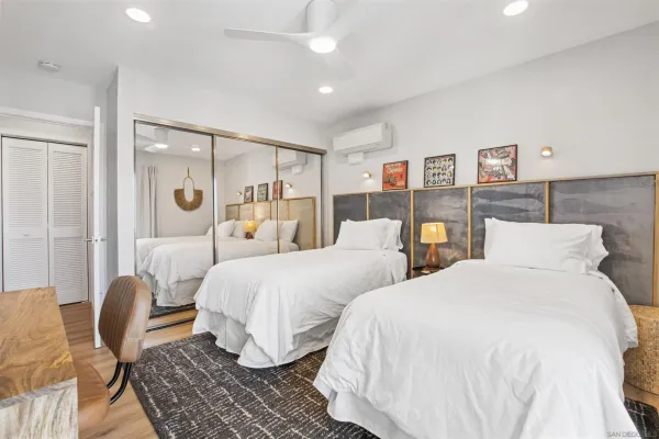 a bedroom with two beds and a table