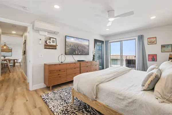 a bedroom with a bed and a flat screen tv