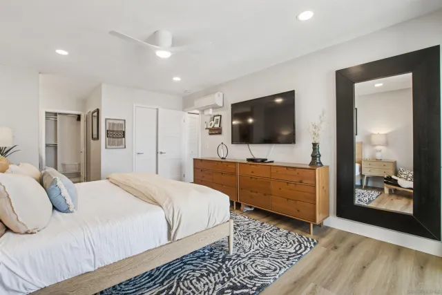 a bedroom with a bed and a flat screen tv
