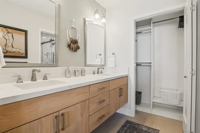 a bathroom with a double vanity sink mirror and double