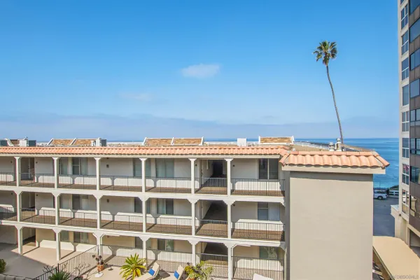 a view of tall building with large windows
