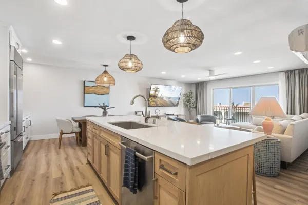a kitchen with a sink and a stove next to a window