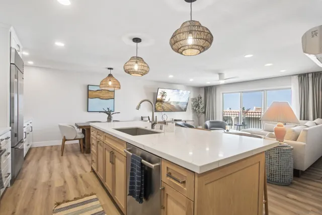 a kitchen with a sink and a stove next to a window