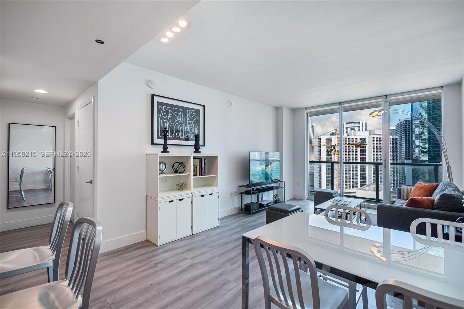 500 Brickell Avenue, Unit 1903 Miami, FL 33131 - Photo 1 of 18 a open dining room with stainless steel appliances furniture a large window and a livingroom view