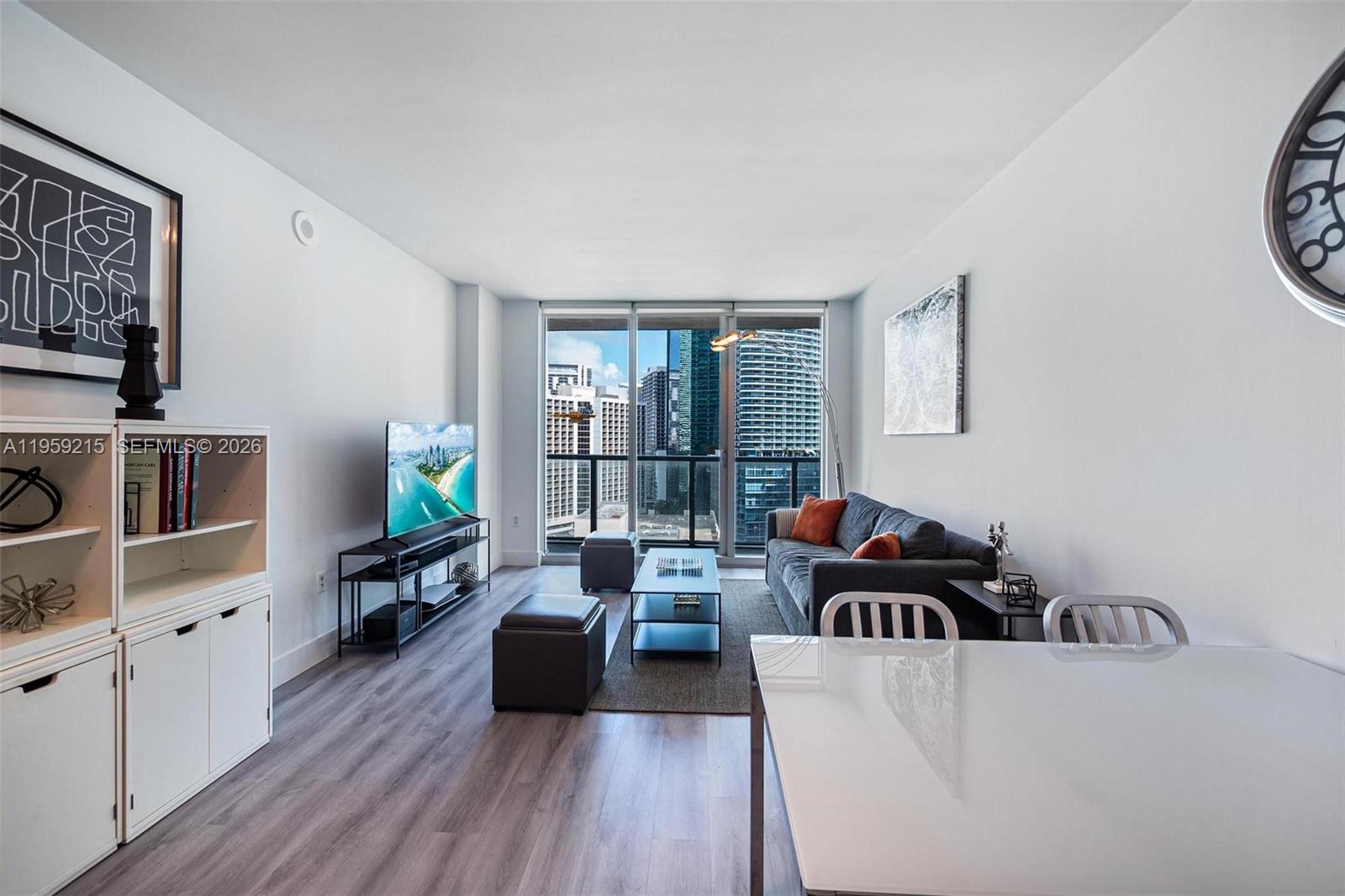 500 Brickell Avenue, Unit 1903 Miami, FL 33131 - Photo 2 of 18 a living room with furniture and a wooden floor