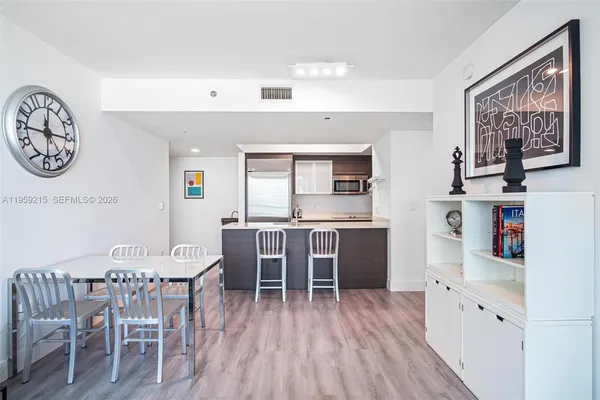 a dining room with furniture and wooden floor