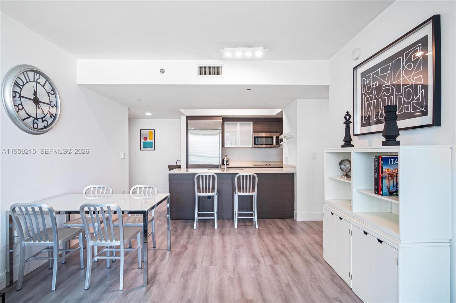 500 Brickell Avenue, Unit 1903 Miami, FL 33131 - Photo 5 of 18 a dining room with furniture and wooden floor