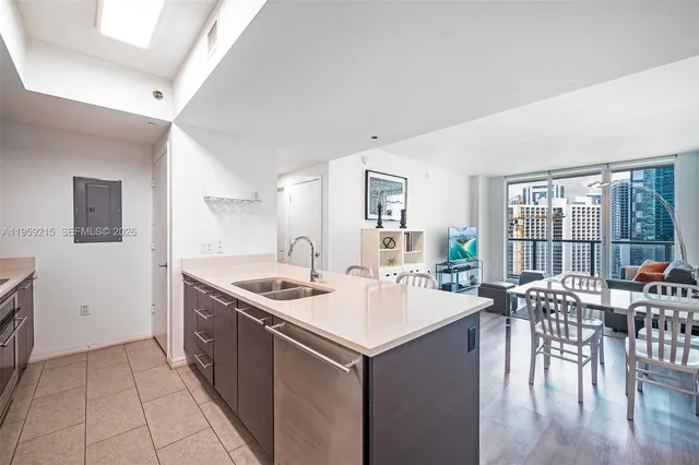 a kitchen with a stove a sink a dining table and chairs