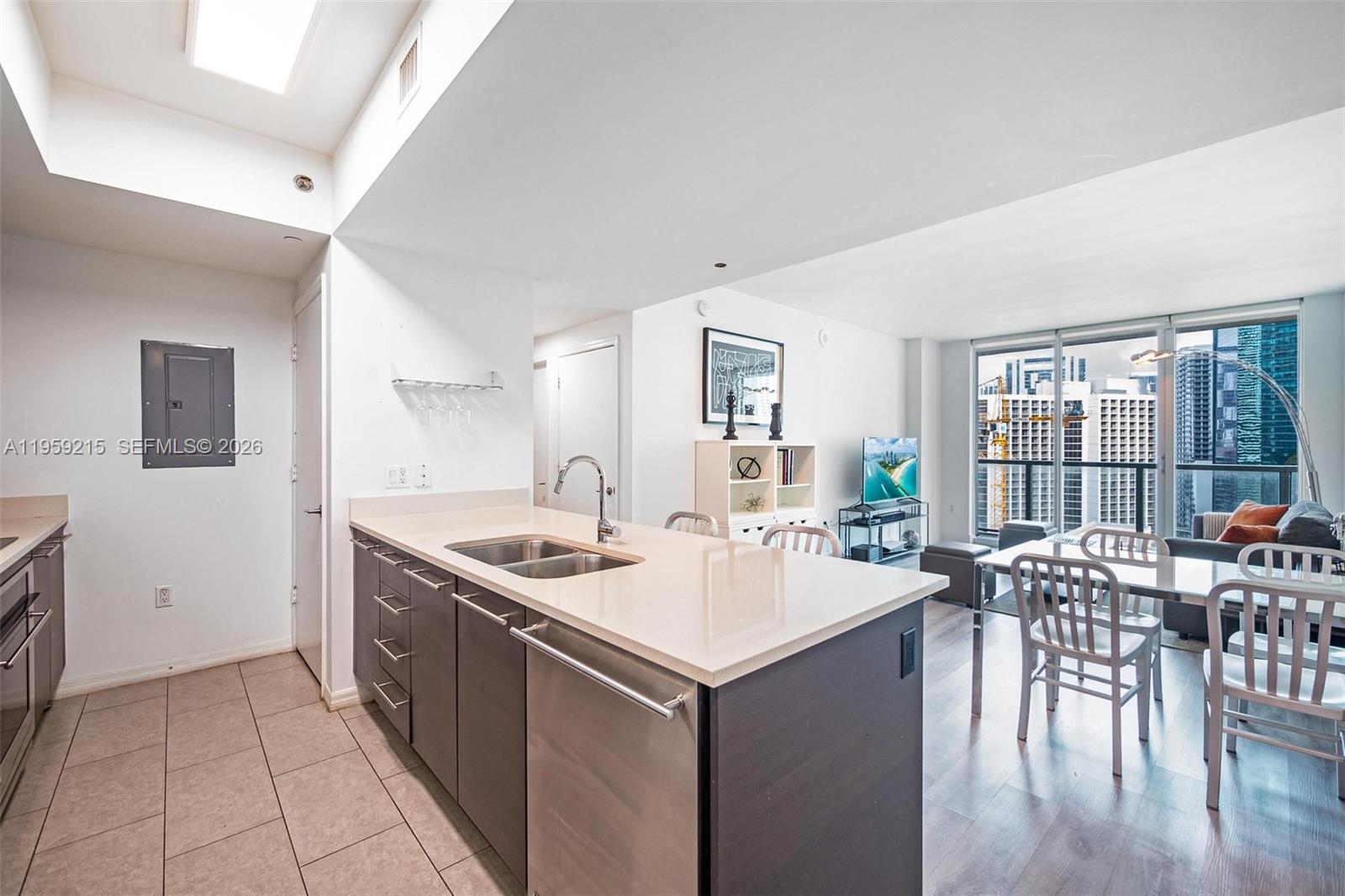 500 Brickell Avenue, Unit 1903 Miami, FL 33131 - Photo 6 of 18 a kitchen with a stove a sink a dining table and chairs
