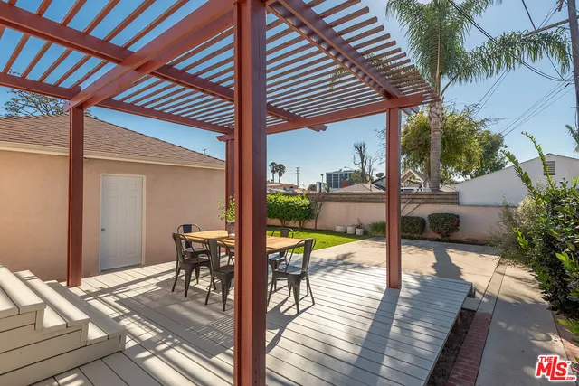 a view of a balcony with chairs and wooden floor