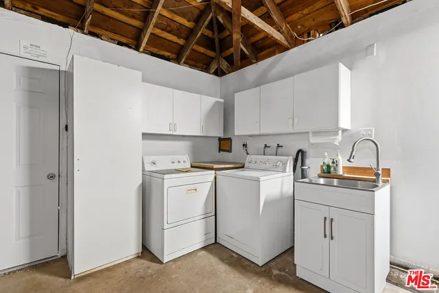 a kitchen with appliances a sink and cabinets