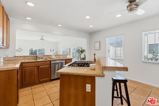 a kitchen with a sink a stove a counter space and dining table
