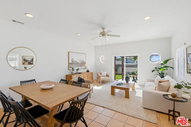 a view of a dining room with furniture and a chandelier