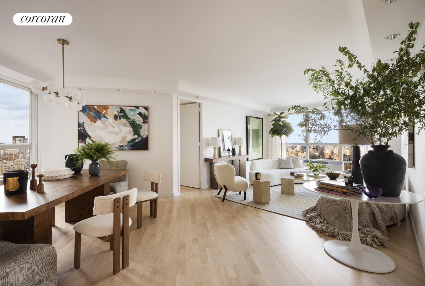 a living room with furniture a rug and a potted plant