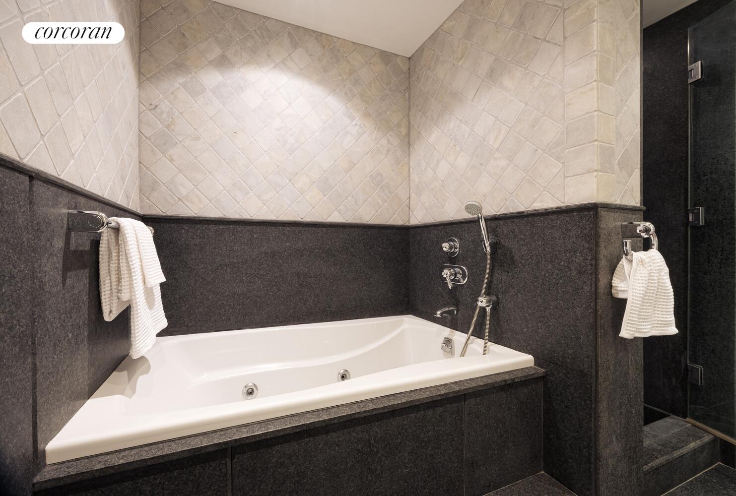 146 West 57th Street, Unit 58A Manhattan, NY 10019 - Photo 10 of 18 a bathroom with a bathtub and a shower