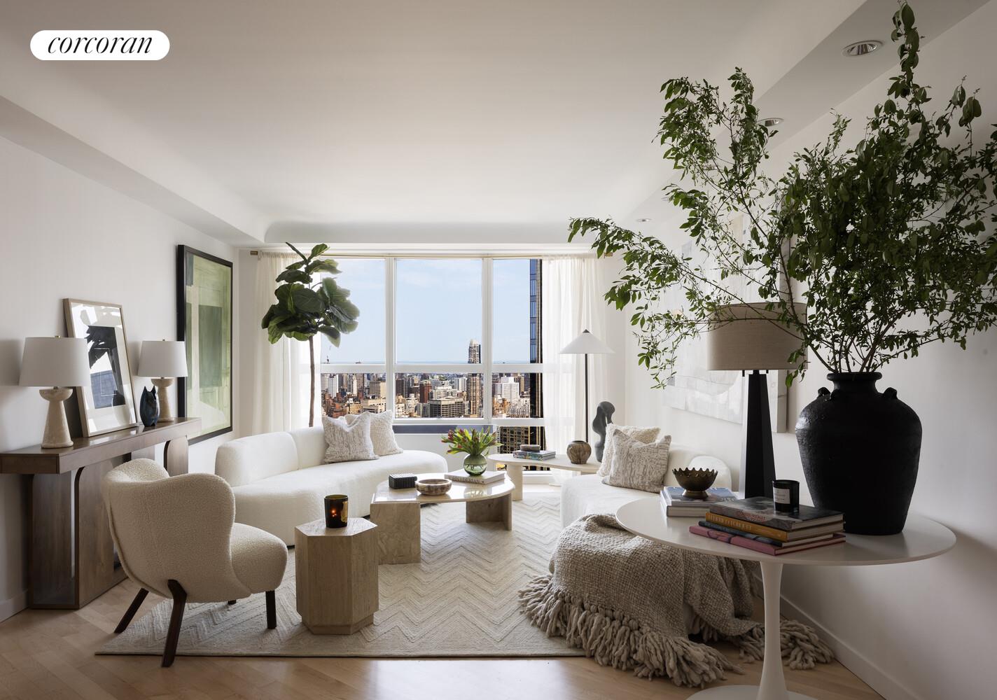 146 West 57th Street, Unit 58A Manhattan, NY 10019 - Photo 3 of 18 a living room with fireplace furniture and a potted plant