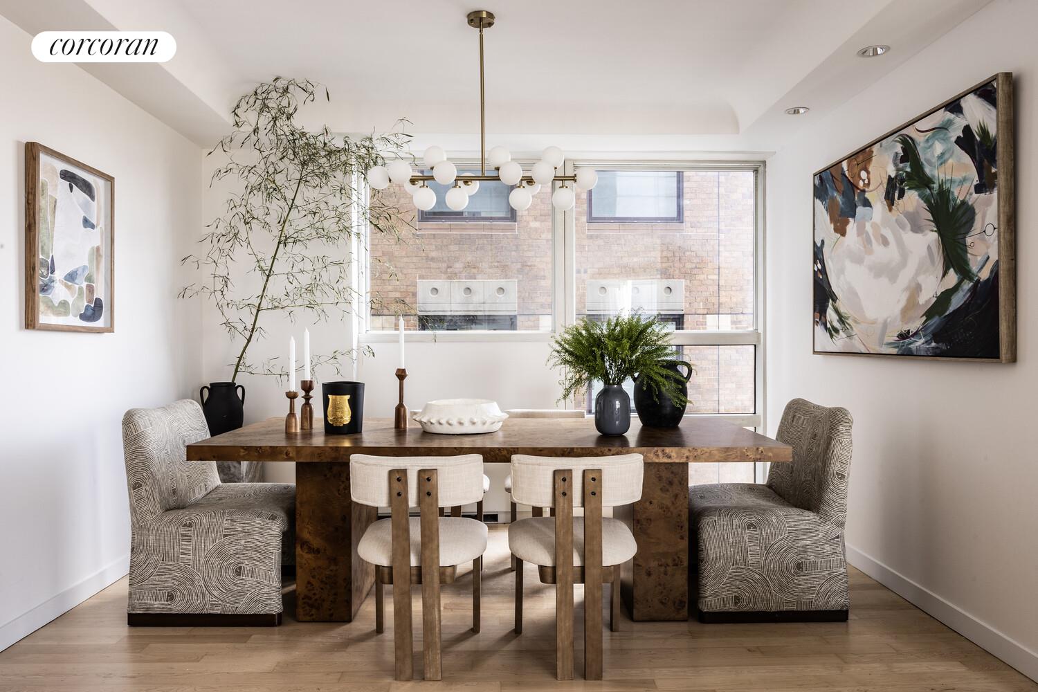 146 West 57th Street, Unit 58A Manhattan, NY 10019 - Photo 5 of 18 a view of a dining room with furniture and wooden floor
