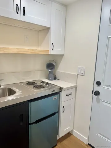 a view of a kitchen with a sink and a stove top oven