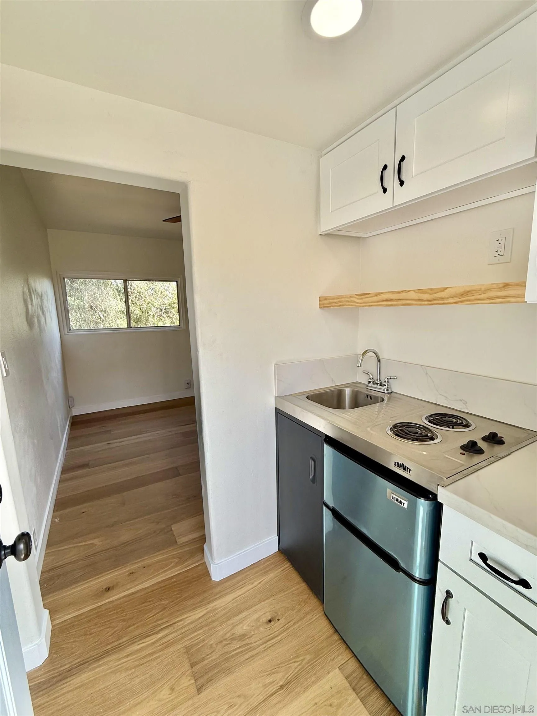 2331 Shamrock Street, Unit STUDIO San Diego, CA 92105 - Photo 2 of 13 a kitchen with a sink stove and cabinets
