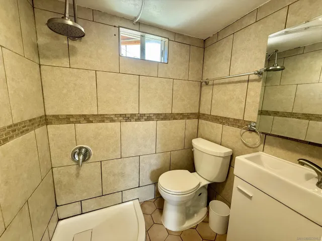 a bathroom with a toilet and a shower