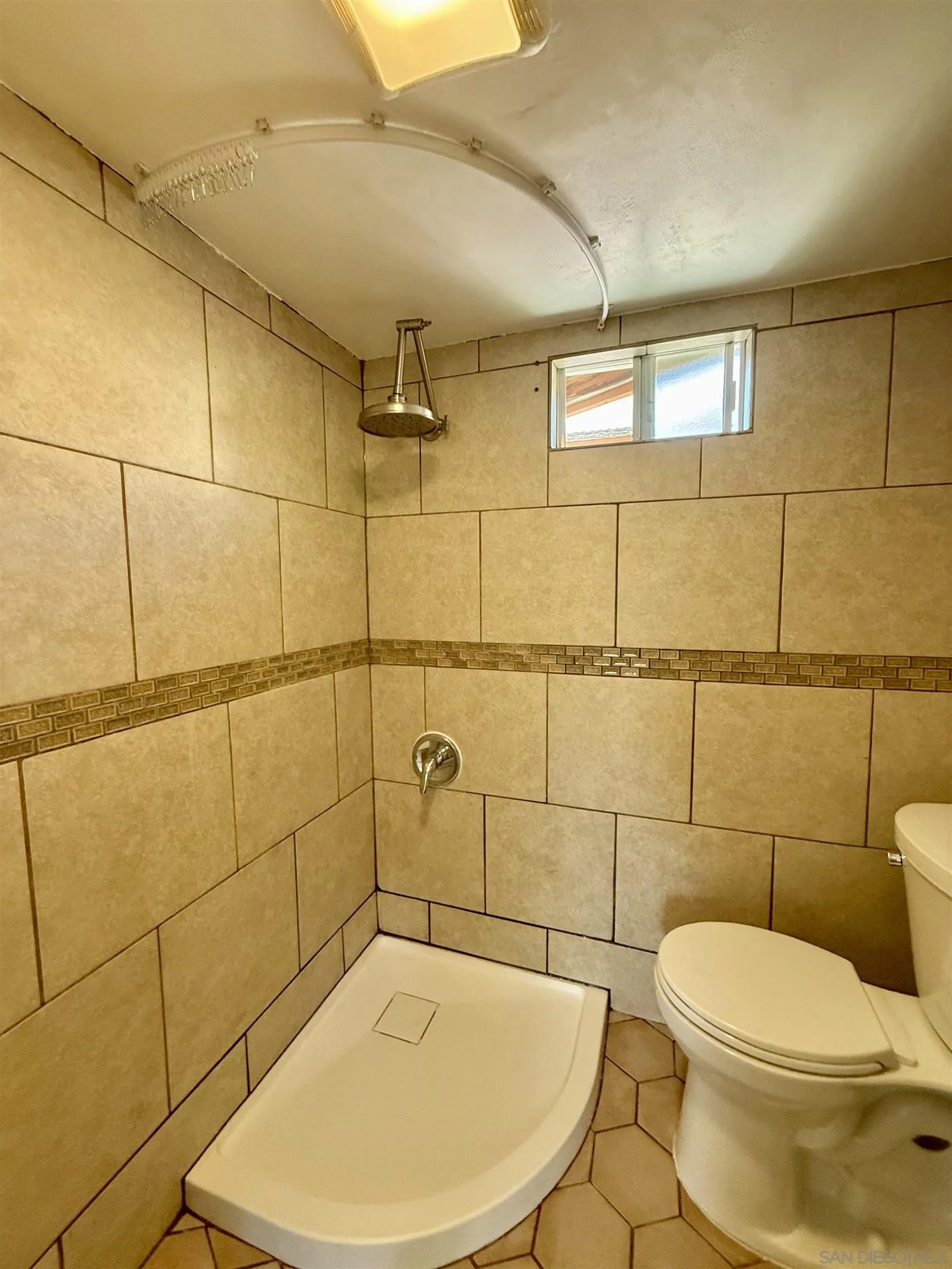 2331 Shamrock Street, Unit STUDIO San Diego, CA 92105 - Photo 9 of 13 a bathroom with a toilet and shower