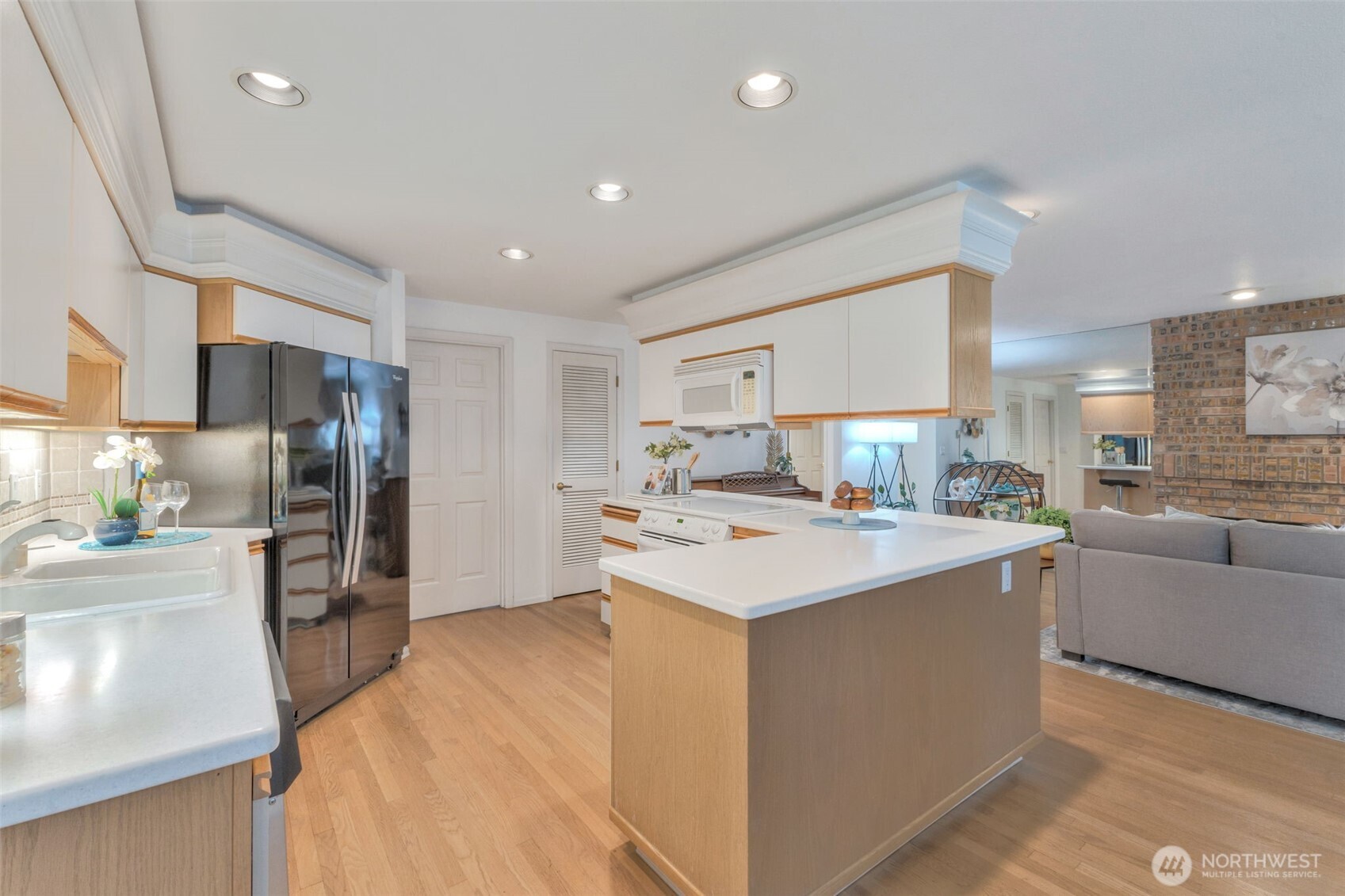 311 Keach Loop Steilacoom, WA 98388 - Photo 13 of 38 a kitchen with stainless steel appliances a sink stove and refrigerator