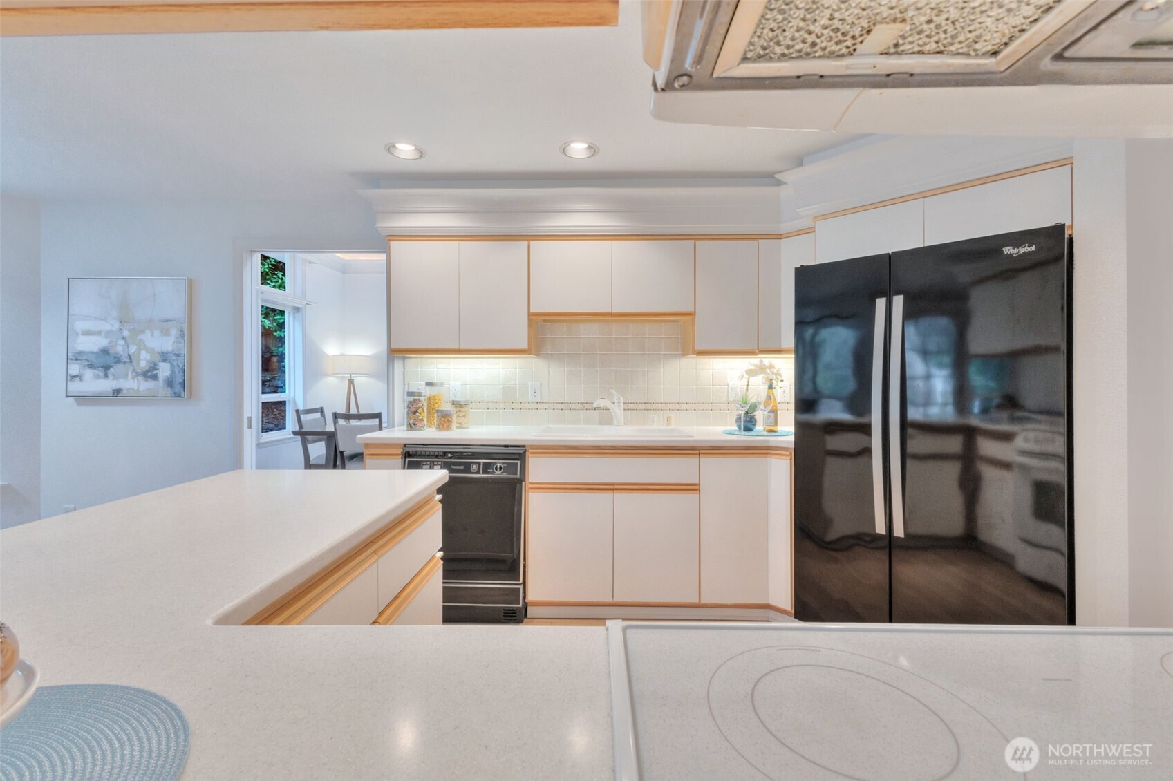 311 Keach Loop Steilacoom, WA 98388 - Photo 15 of 38 a kitchen with stainless steel appliances kitchen island a refrigerator sink and cabinets