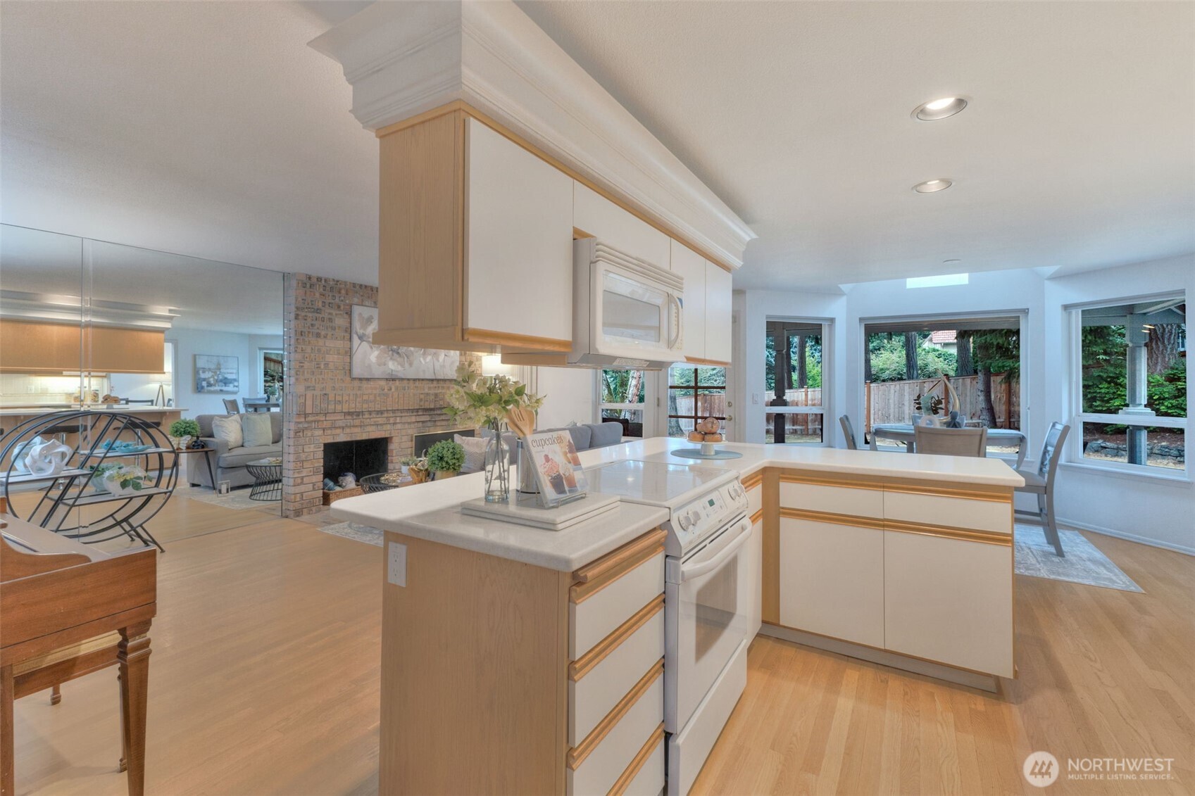311 Keach Loop Steilacoom, WA 98388 - Photo 16 of 38 a open kitchen with sink cabinets and dining table