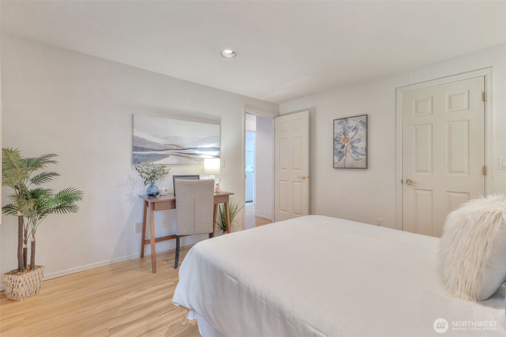 311 Keach Loop Steilacoom, WA 98388 - Photo 20 of 38 a bedroom with a bed and a potted plant