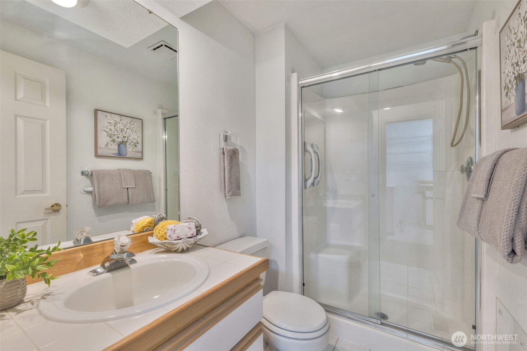 311 Keach Loop Steilacoom, WA 98388 - Photo 21 of 38 a bathroom with a sink toilet and shower