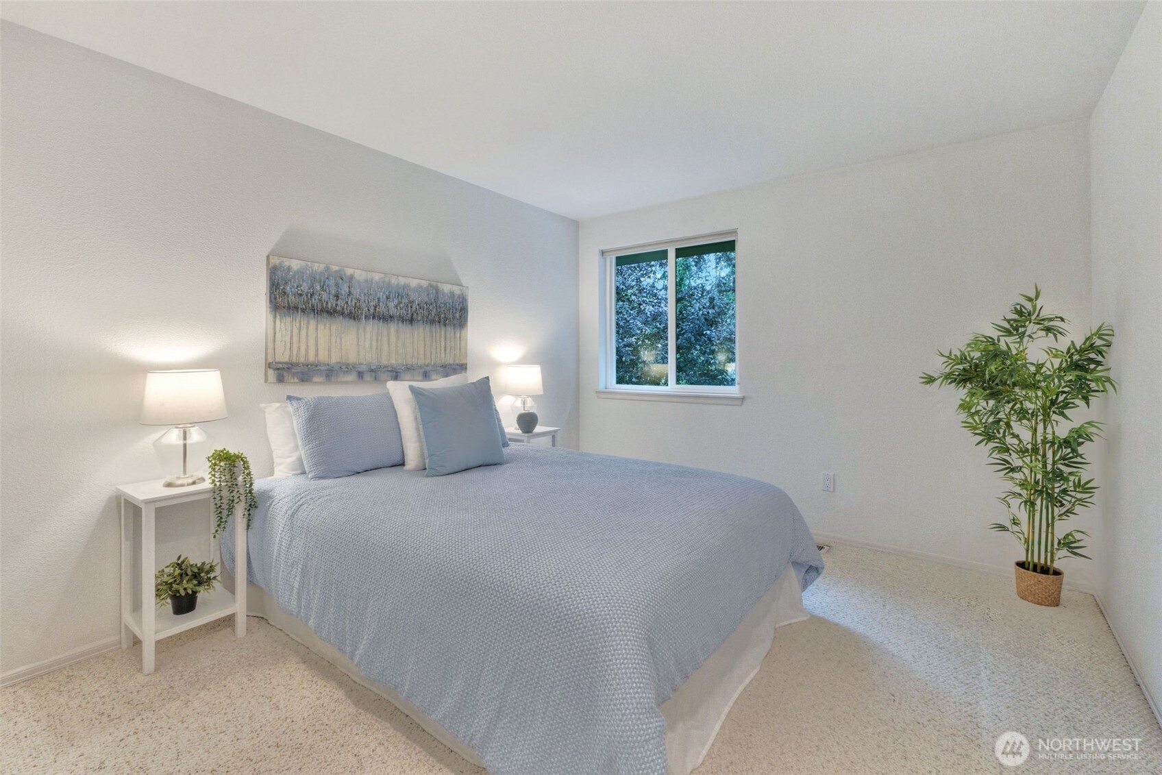 311 Keach Loop Steilacoom, WA 98388 - Photo 25 of 38 a bedroom with a bed and a potted plant