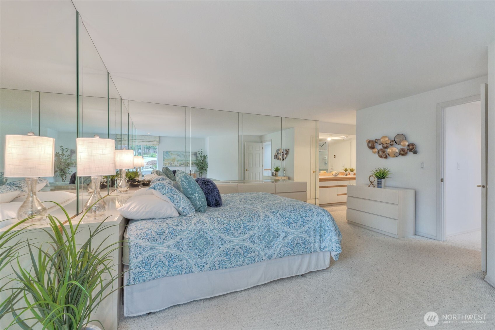 311 Keach Loop Steilacoom, WA 98388 - Photo 29 of 38 a bedroom with a large bed and a chandelier