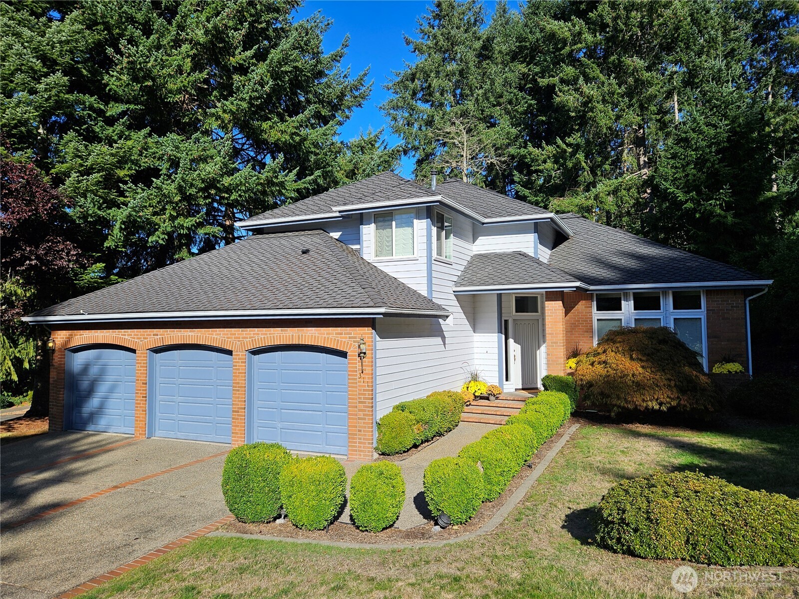 311 Keach Loop Steilacoom, WA 98388 - Photo 3 of 38 a front view of a house with a yard and garage