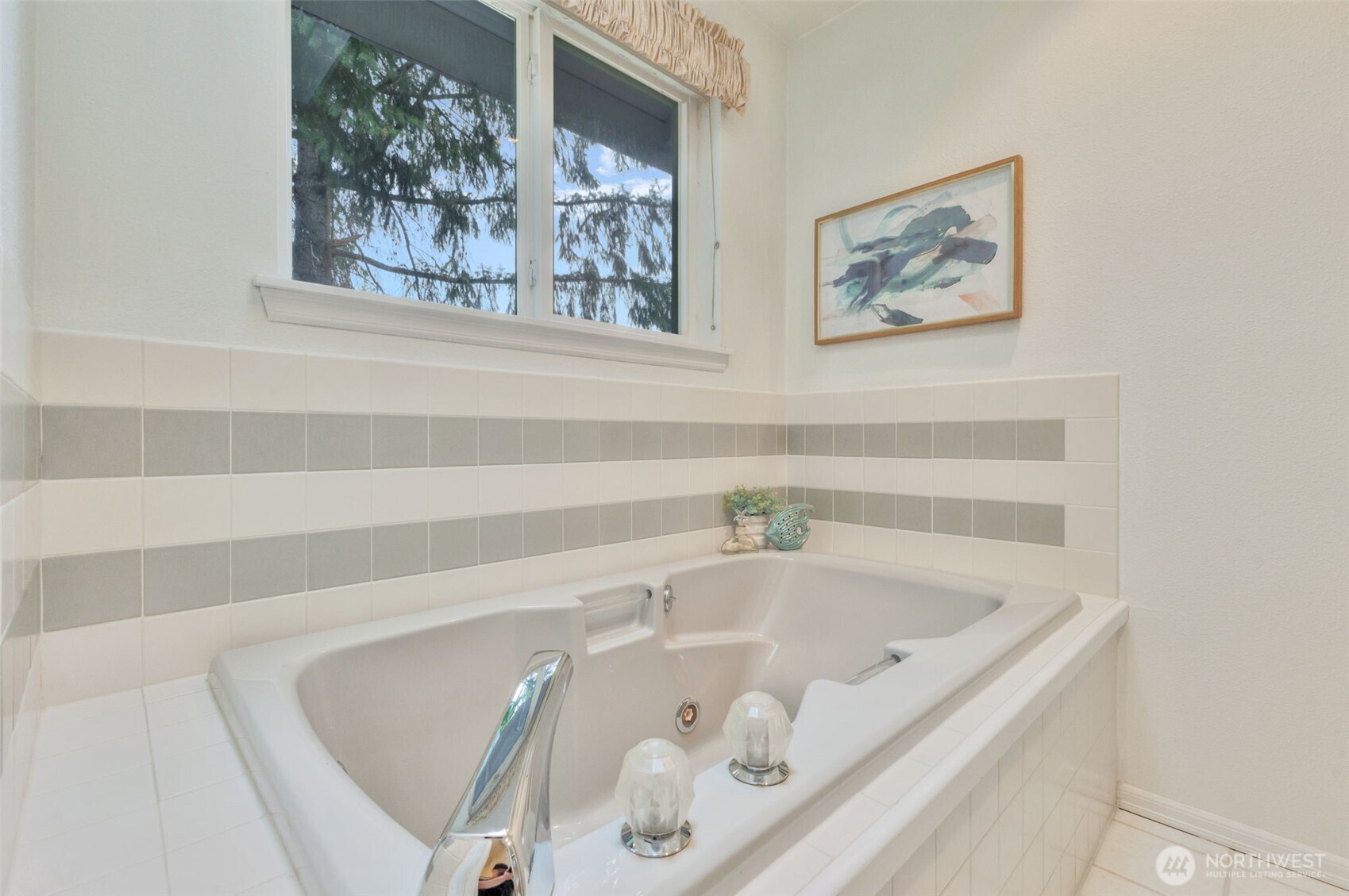 311 Keach Loop Steilacoom, WA 98388 - Photo 31 of 38 a bathroom with bathtub and window