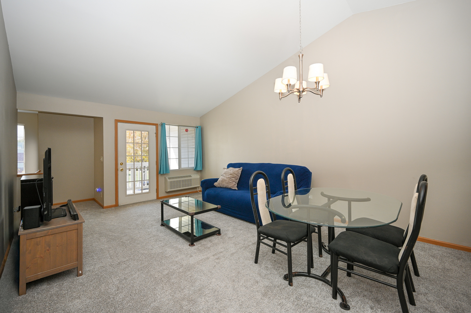 1425 McClure Road, Unit 1425 Aurora, IL 60505 - Photo 2 of 12 a living room with furniture a window and a flat screen tv