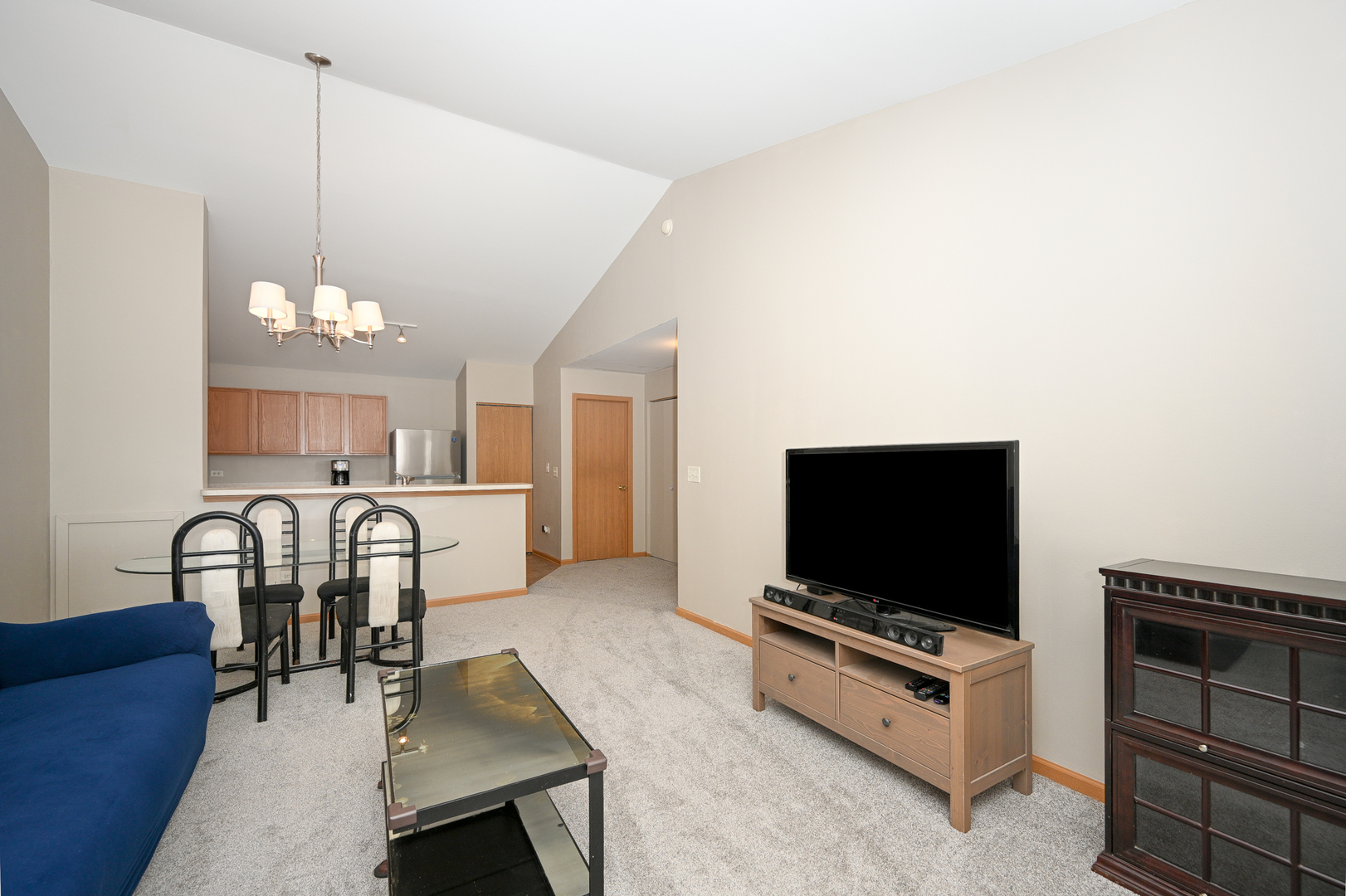 1425 McClure Road, Unit 1425 Aurora, IL 60505 - Photo 3 of 12 a living room with furniture and a flat screen tv