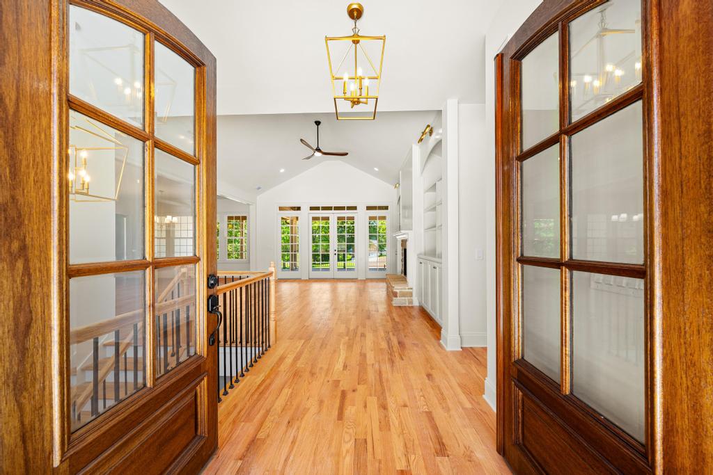 707 Vickery Street Extension Hartwell, GA 30643 - Photo 3 of 50 Walk through French doors into a sun-drenched living area with vaulted ceilings and rich hardwood floors.