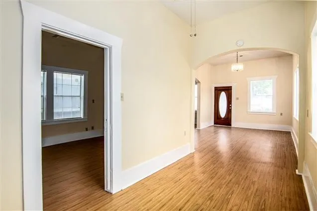 a view of a room with wooden floor and a window