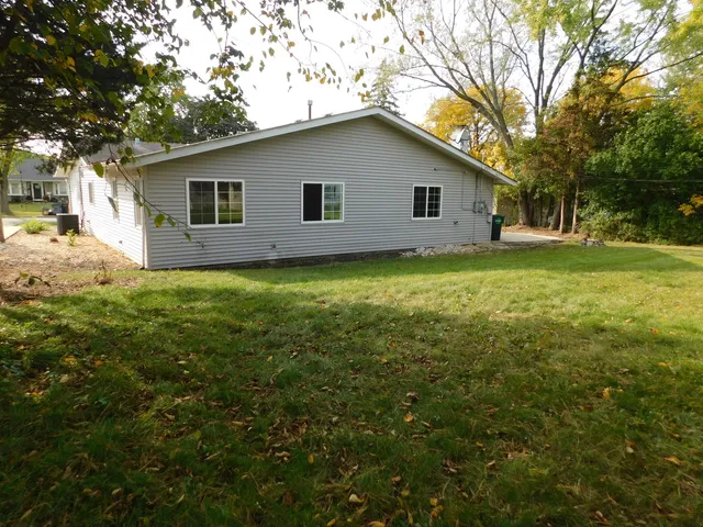 a view of a backyard with large trees