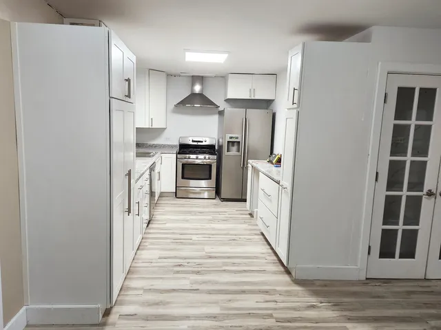 a kitchen with stainless steel appliances a refrigerator and a stove