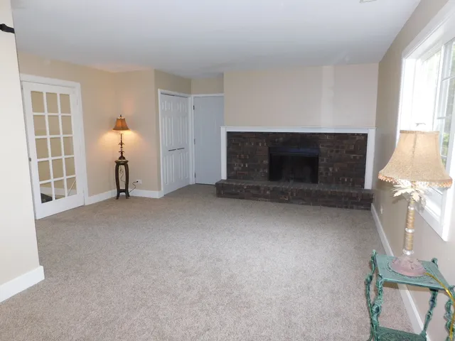 a view of a livingroom with furniture and a fireplace