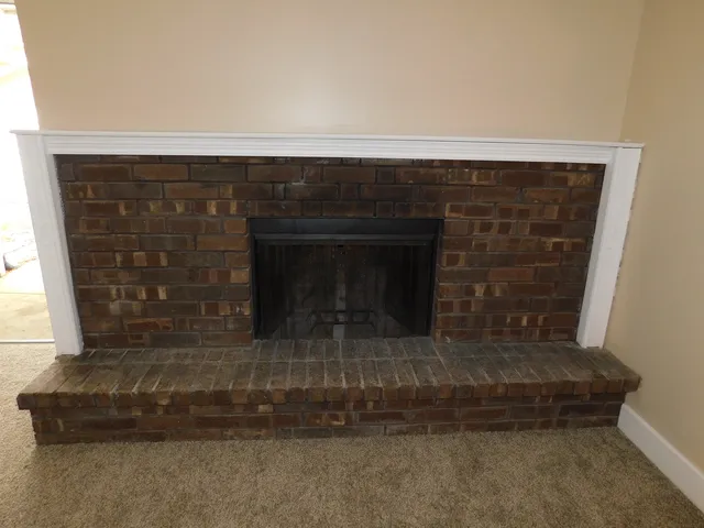 a fireplace with a vase