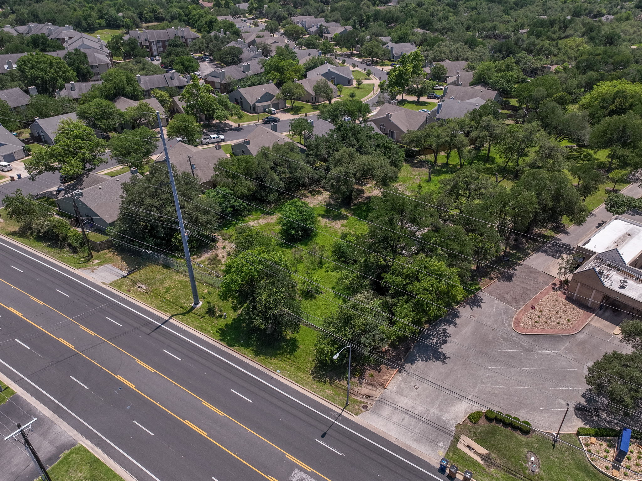 12182 Jollyville Road Austin, TX 78759 - Photo 21 of 25 Expansive undeveloped parcel with mature trees and direct road frontage