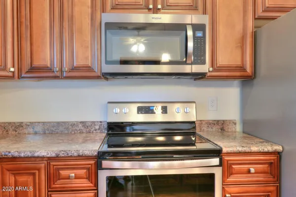 a stove top oven sitting inside of a kitchen