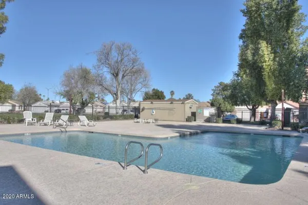 a view of a house with pool and sitting area